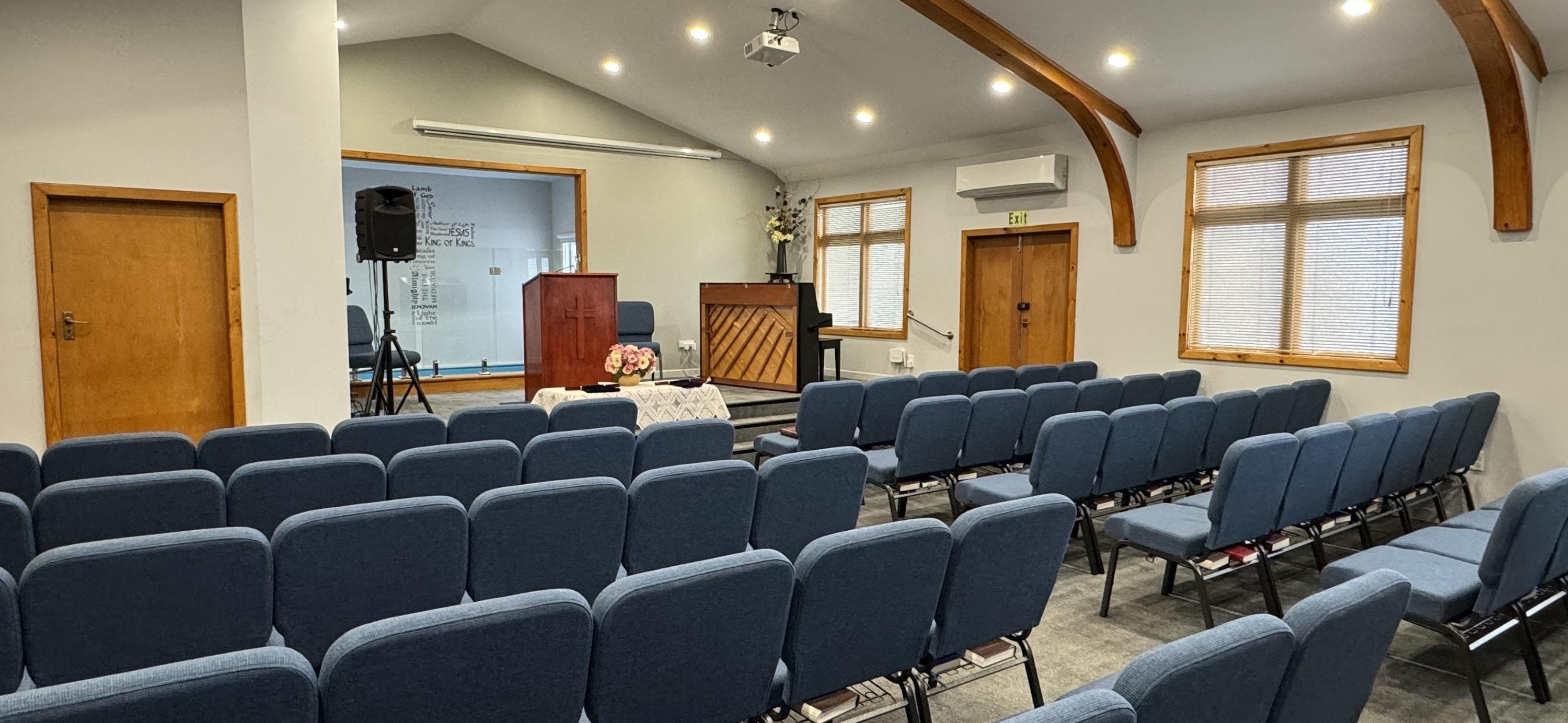 The pulpit and piano at the front of the auditorium